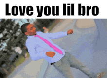 a man in a pink tie is dancing with the words love you lil bro above him