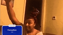 a woman in a room with a sign that says ' canadian ' on it