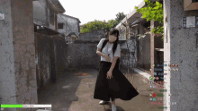 a woman in a black skirt is standing in a narrow alleyway with a green bar that says 80