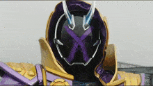 a close up of a mask with a purple x in the middle
