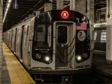 a subway train with the letter h on the front of it