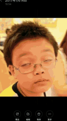 a picture of a boy wearing glasses is taken in 2017