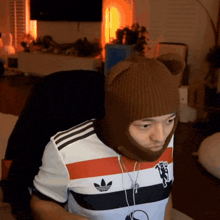 a man wearing a manchester united shirt and a beanie