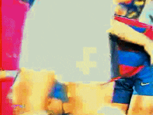 a pixelated image of a man in a striped shirt and shorts