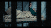 a person laying on a bed with a blanket