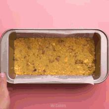 a loaf pan filled with a crumbly crust and the words mr.cakes written on the bottom