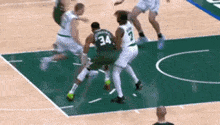 a group of basketball players are playing on a court .