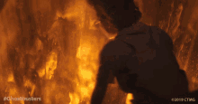 a person is standing in front of a fire with the hashtag #ghostbusters on the bottom