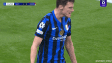 a soccer player wearing a blue and black jersey that says betsson on the sleeve