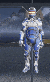 a man in a blue and white armor stands in front of a large window