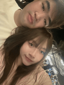 a man and woman are posing for a picture together