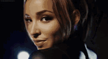 a woman with a nose ring is smiling and looking over her shoulder .