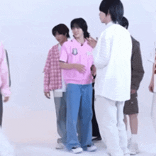a group of young men are standing in a row .