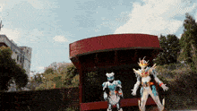 a couple of anime characters standing in front of a building