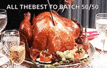 a large roasted turkey is sitting on a table with glasses of wine ..
