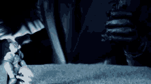 a person in black gloves is holding a toy figure in their hand