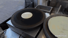 a pan with a pancake on it and the words made in animatica
