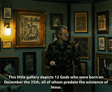 a man stands in front of a wall of framed pictures with the caption this little gallery depicts 12 gods who were born on december