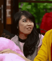 a woman in a yellow jacket sits next to a man in a red shirt