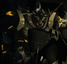 a close up of a transformer robot in a dark room with lights on .
