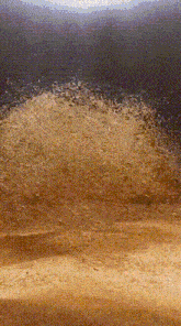 a painting of a sandy beach with a dark sky