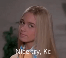a blonde woman with the words nice try kc written on her face