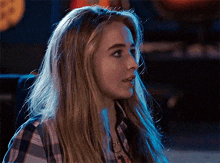 a close up of a woman 's face with long blonde hair