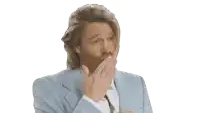 a man with long hair and a beard is clapping his hands