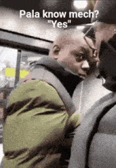 a man in a green jacket talks to another man in a black jacket