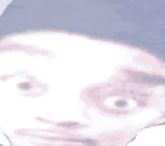 a close up of a person 's face with a surprised look on his face