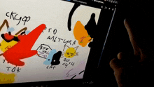 a person is holding a tablet that has a drawing of a red spongebob and the words " kto to " on it