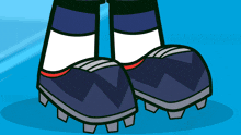 a pair of soccer cleats with a red stripe on the bottom