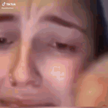 a close up of a woman 's face with a tiktok watermark on the bottom