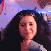a woman with a ring on her finger is wearing a headset