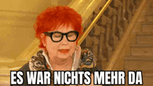 a woman with red hair and glasses is standing on a set of stairs .