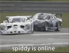 a picture of two race cars on a track with the caption spiddy is online