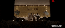 a group of people standing in front of a sign that says " talent time "