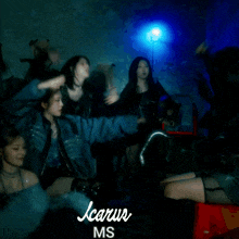 a group of girls are dancing in a dark room with the words icarus ms written on the bottom