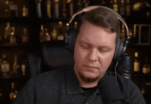 a man wearing headphones with the letter e on the left side