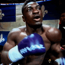 a boxer wearing a pair of purple gloves that say ' king ' on it