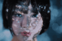 a close up of a woman 's face with a lot of reflections on it