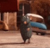 a cartoon rat is walking down a street in front of a building .