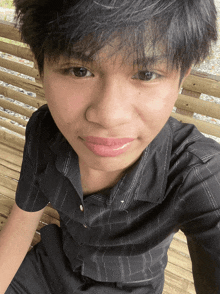 a close up of a person 's face with a striped shirt on