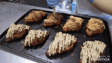 a bunch of croissants are sitting on a tray that says made in animonica