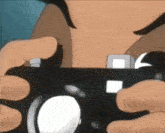 a close up of a person holding a camera in their hand