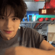 a man stands in front of a sign that says rj