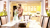 a man and woman hugging in a dining room