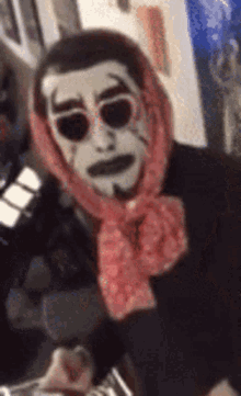 a man with a scarf around his head and sunglasses on