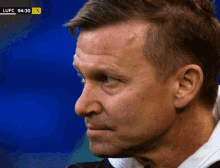 a close up of a man 's face with a score of lufc 94:30 5
