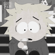 a cartoon character from south park is holding a cup of coffee